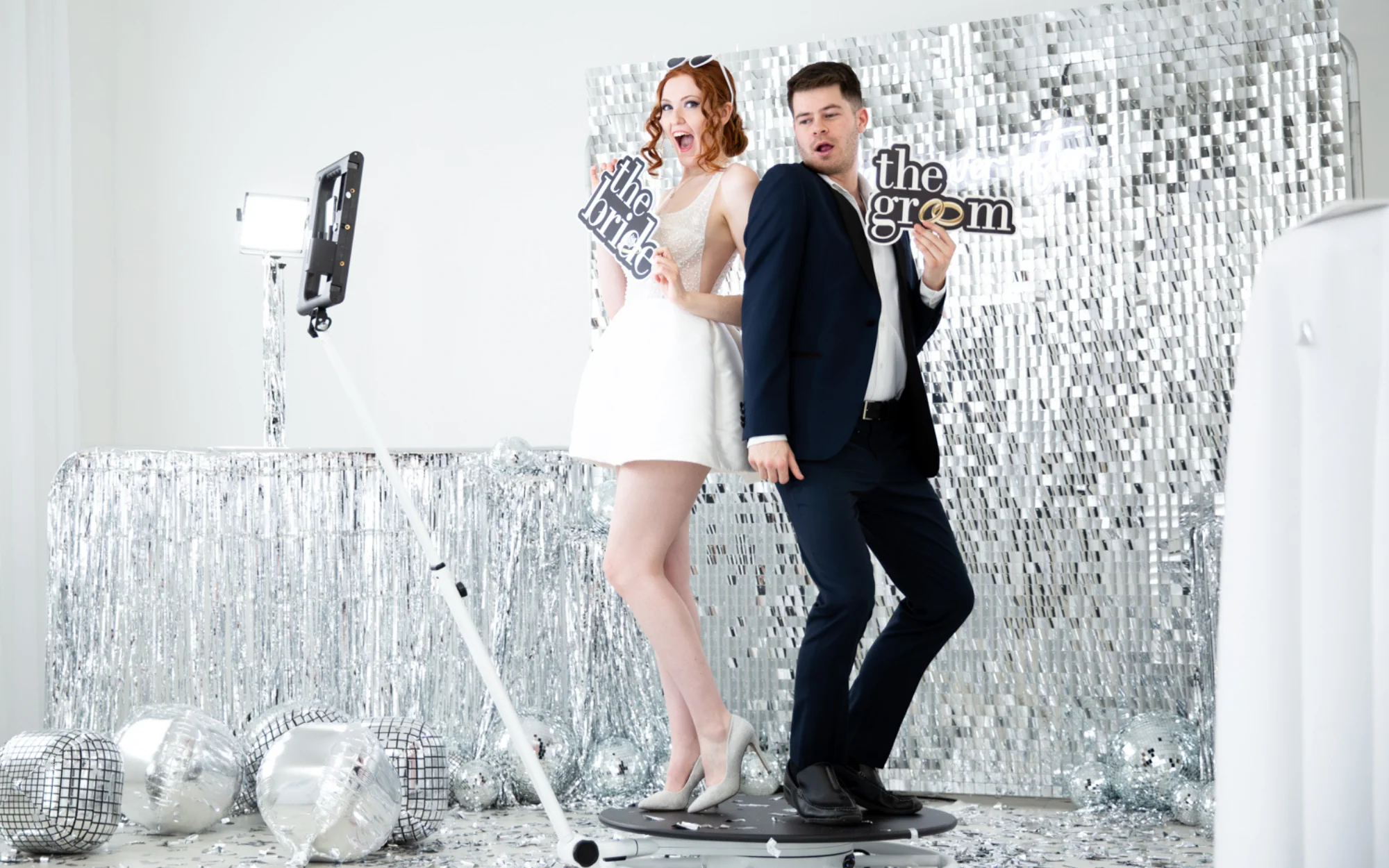 Central Oregon 360 photo booth at a wedding with silver sequin backdrop