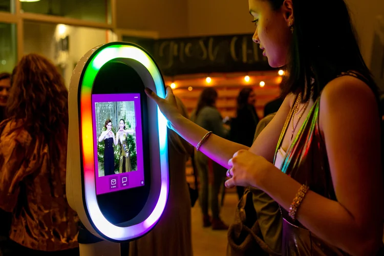 Guest using the Bend Booth touchscreen to capture a photo at a Central Oregon event