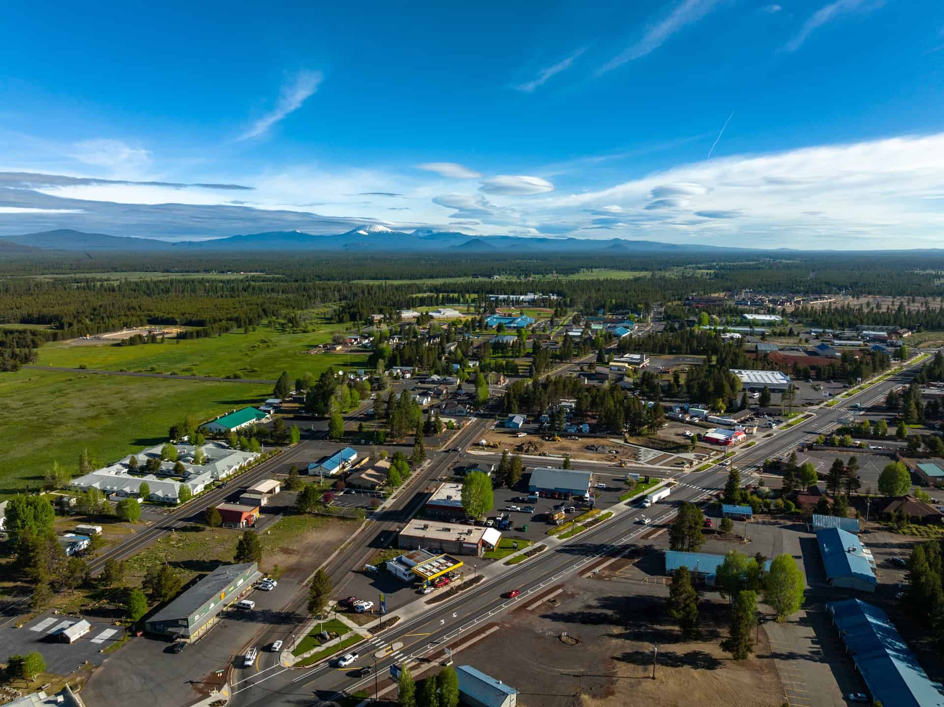Aerial view of La Pine, Oregon with the Cascade Mountains and high-desert pine forest in the distance